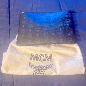 This is a MCM crossbody bag black with the dust bag and strap enclosed